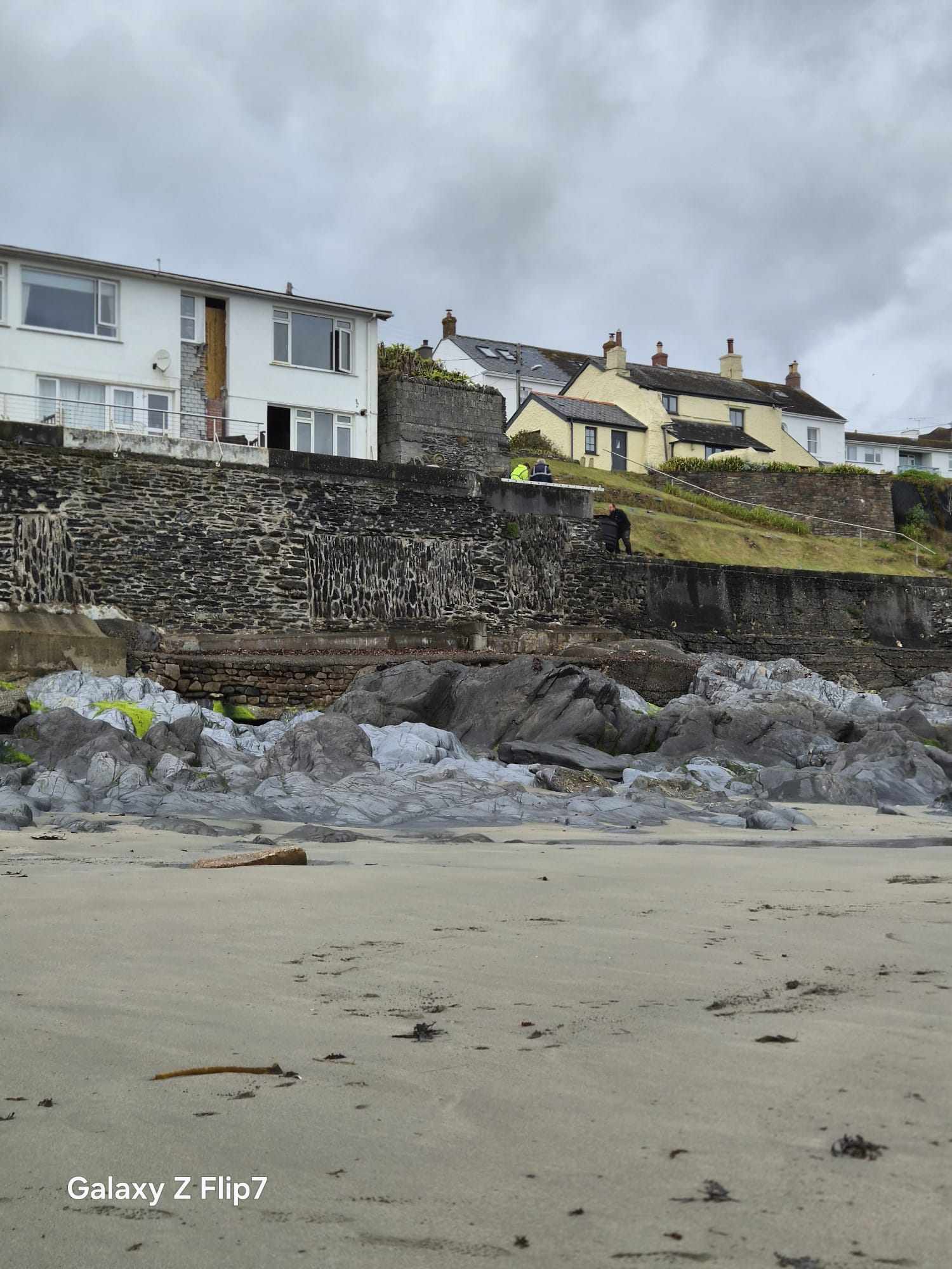 Curlew and its neighbours above Portscatho’s rocky shoreline before refurbishment