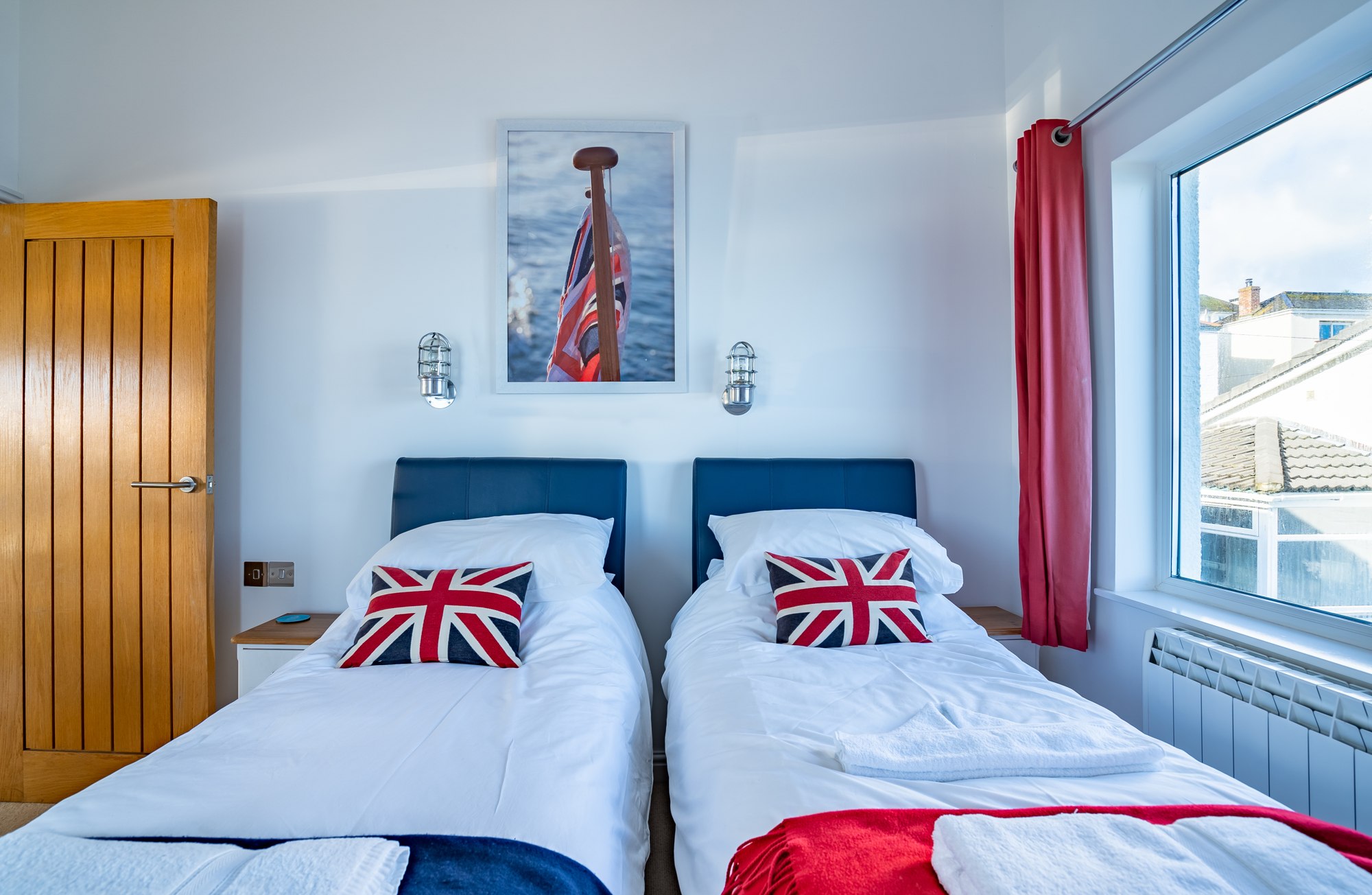 Top Deck bedroom with blue upholstered headboards